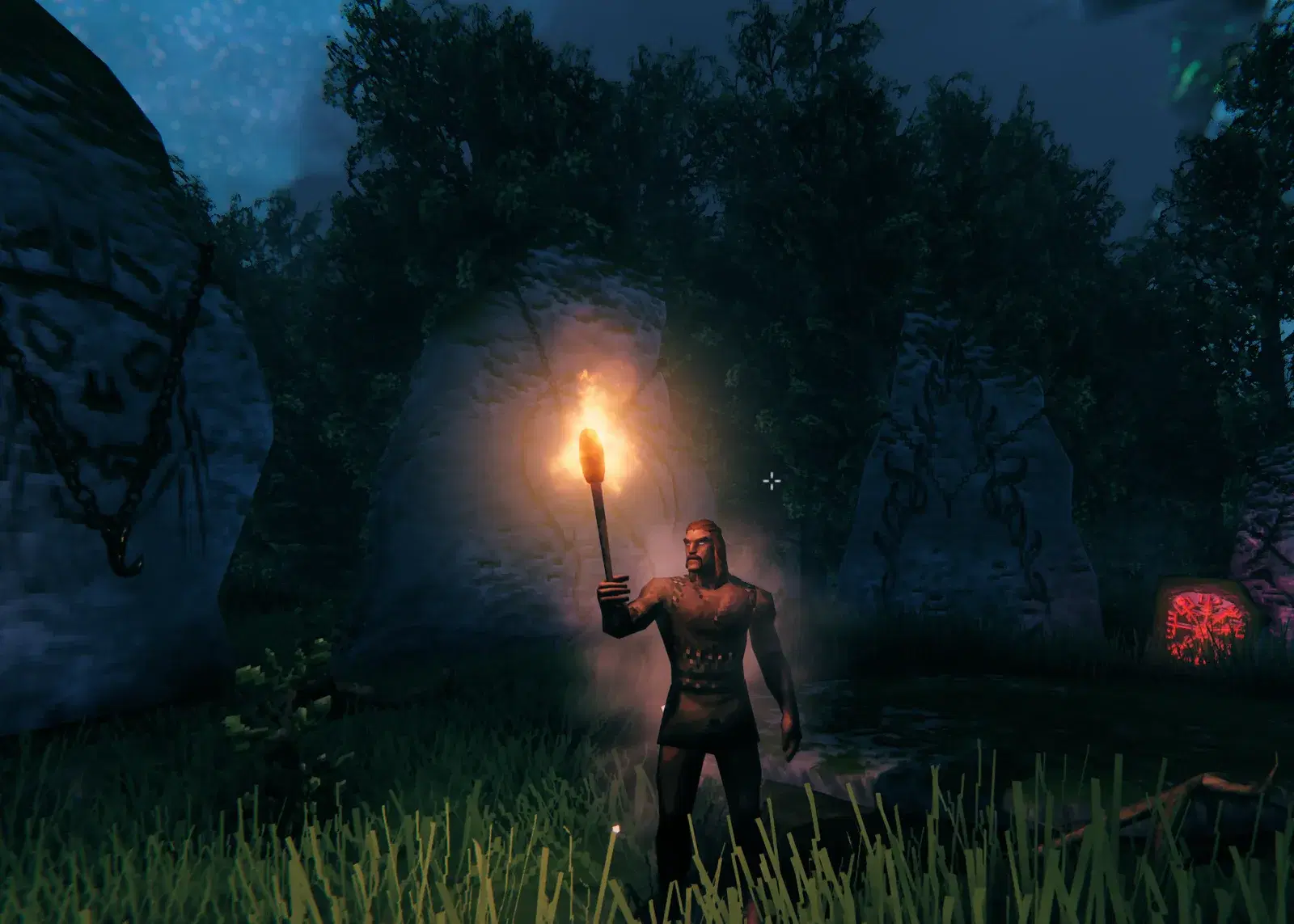 Torchlight glowing on the standing stones at night in Valheim.